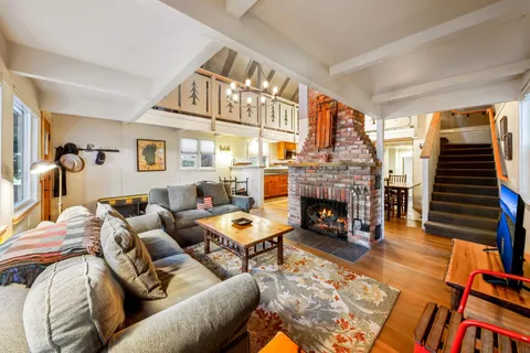 a living room with furniture a fireplace and wall paintings