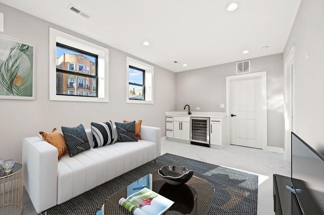 6223 North Albany Avenue, Unit C Chicago, IL 60659 - Photo 6 of 10 a living room with furniture flat screen tv and a fireplace