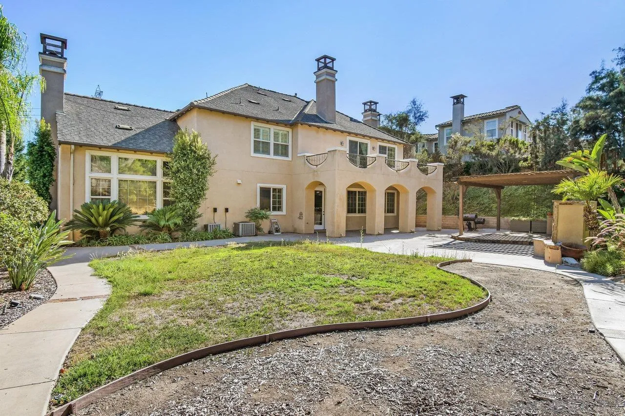 2957 Ranch Gate Road Chula Vista, CA 91914 - Photo 46 of 75 a view of a white house with a big yard and potted plants