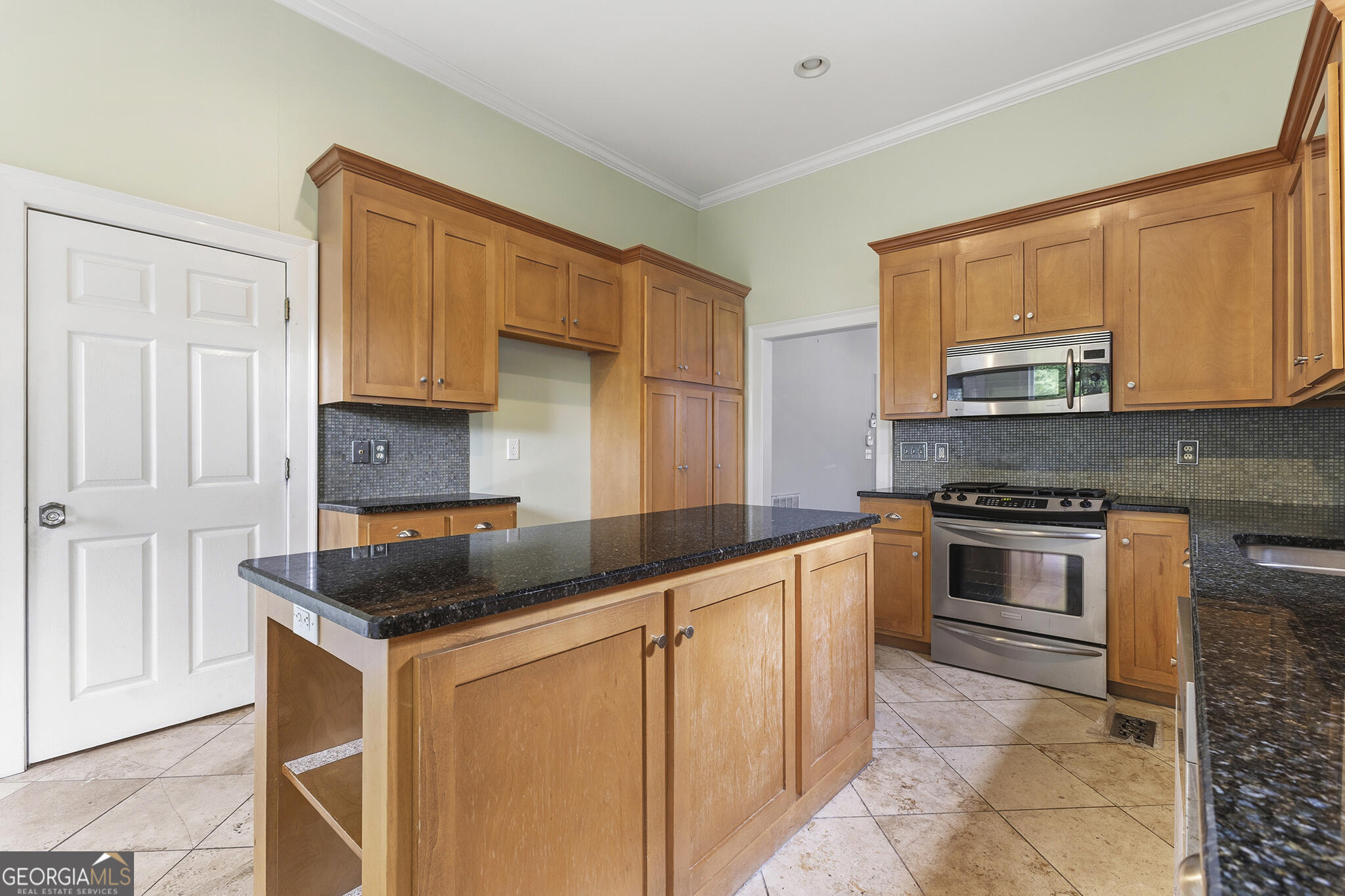 1469 Chestnut Street Macon, GA 31201 - Photo 20 of 26 a kitchen with stainless steel appliances granite countertop a stove a sink and a microwave