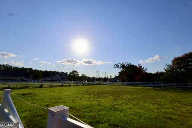 an aerial view of a house with a yard and lake view