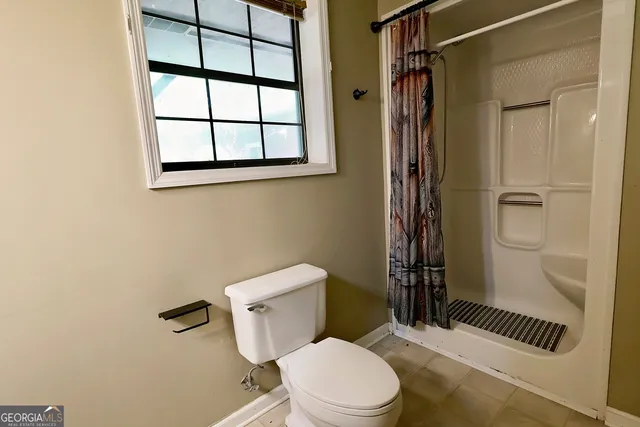 a white toilet sitting next to a bathroom sink