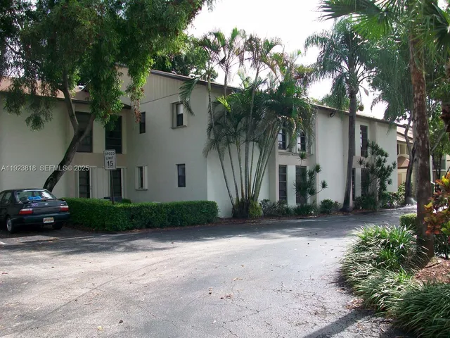 a view of a car park in front of house