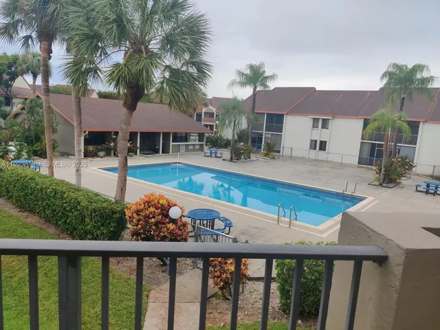 a view of a house with swimming pool and sitting area