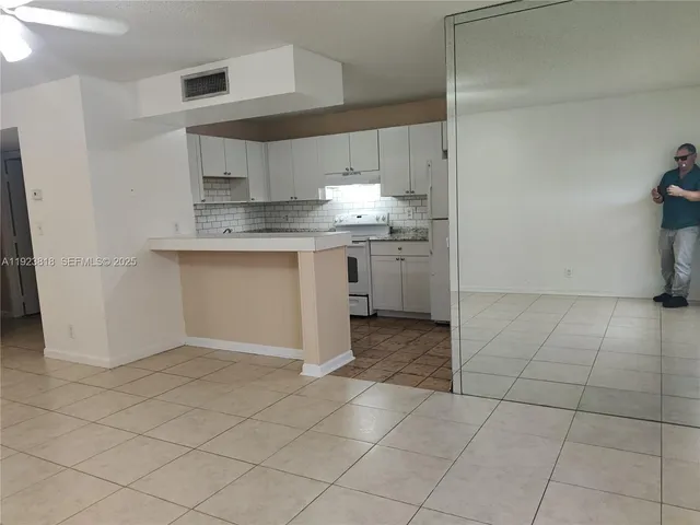 a kitchen with stainless steel appliances granite countertop a sink and cabinets