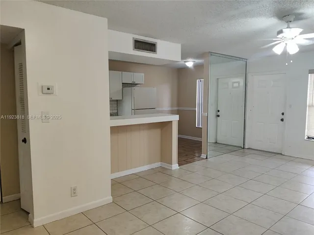 an empty room with a bathroom and a sink