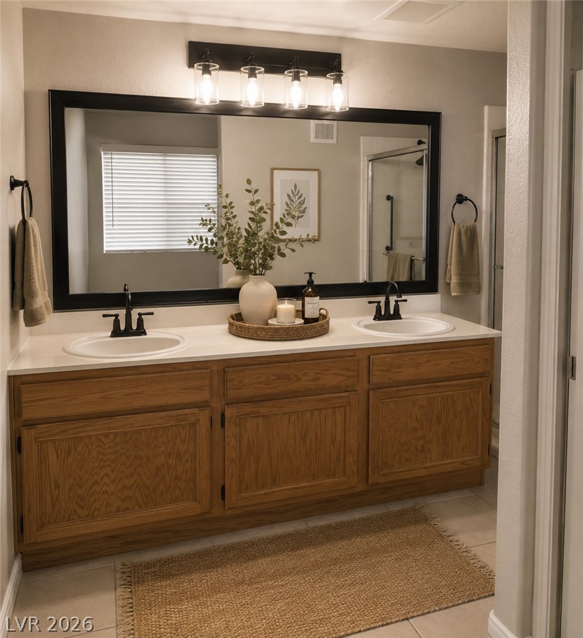 346 Seine Way Henderson, NV 89014 - Photo 9 of 24 A well-appointed primary bathroom features a dual vanity with ample storage and modern fixtures.