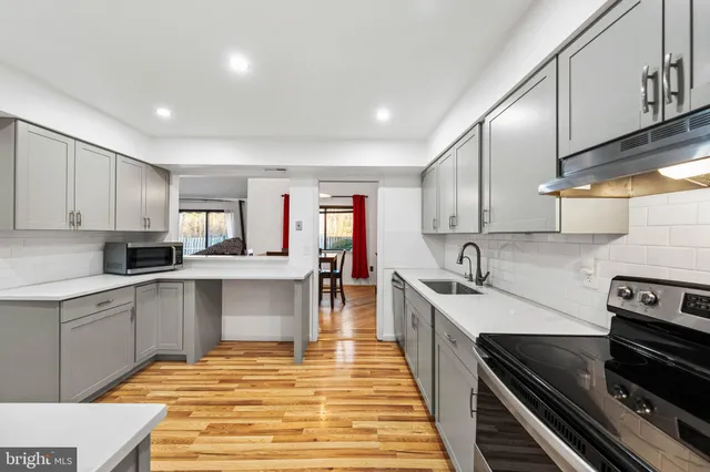 a kitchen with a sink stove and cabinets