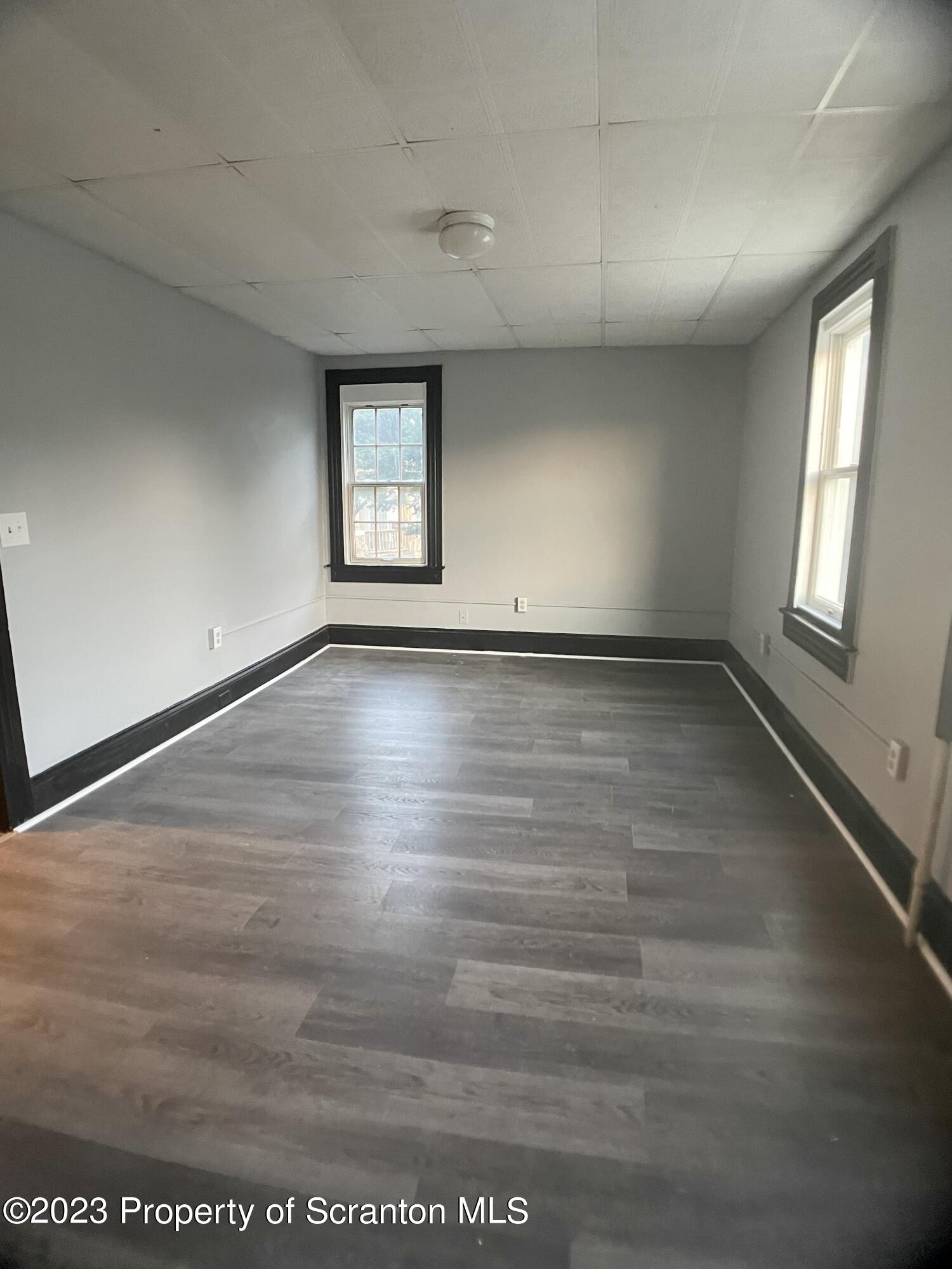 619 Green Ridge Street Scranton, PA 18509 - Photo 18 of 31 an empty room with wooden floor and windows