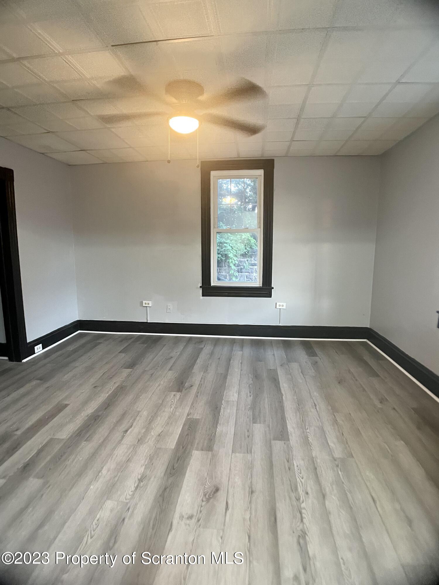 619 Green Ridge Street Scranton, PA 18509 - Photo 6 of 31 a view of a room with wooden floor and window