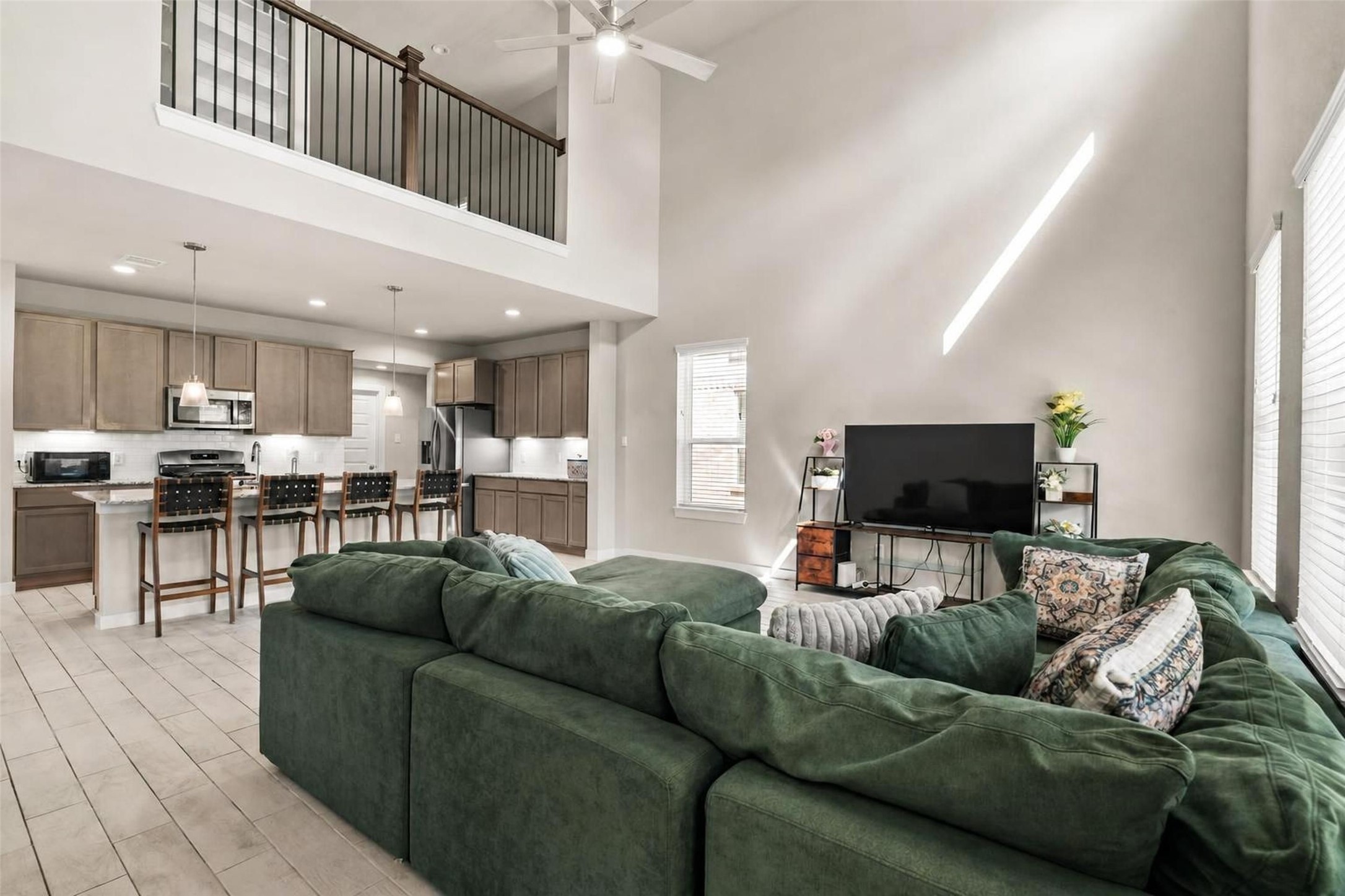 22939 Aspen Vista Dr Spring Spring, TX 77373 - Photo 2 of 29 From the soaring ceilings to the open staircase and second floor overlook, this thoughtfully designed living space creates an inviting atmosphere where everyone feels connected.