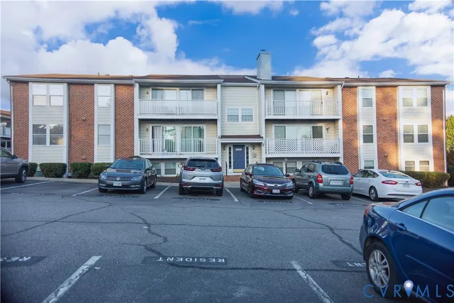 a view of a cars park in front of a building