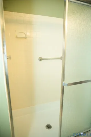 a white toilet sitting next to a shower