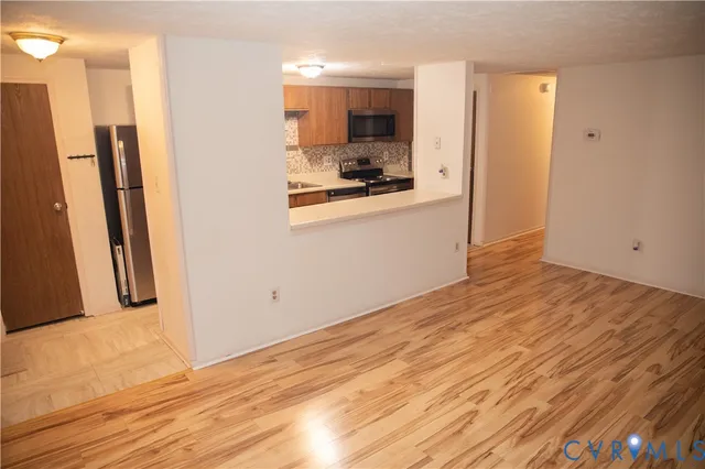 a view of a kitchen with wooden floor and a sink