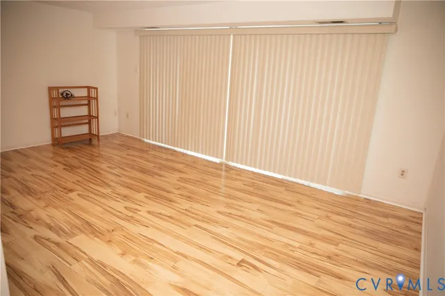a view of wooden floor and windows in a room