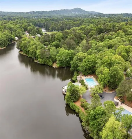 a view of a swimming pool with a patio and a yard