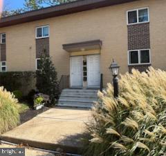 2032 Maple Avenue, Unit 8 Haddon Heights, NJ 08035 - Photo 11 of 12 a front view of a house with garden