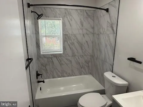 a bathroom with a toilet and a bathtub