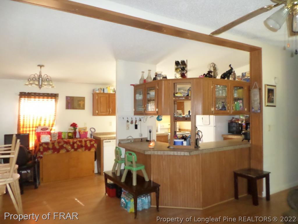 552 Lakerun Drive Bunnlevel, NC 28323 - Photo 14 of 31 a dining room with lots of furniture and chandelier