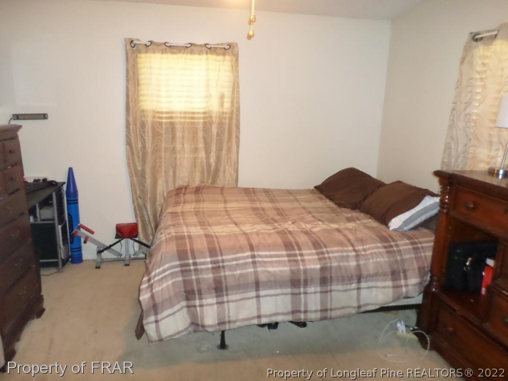 552 Lakerun Drive Bunnlevel, NC 28323 - Photo 15 of 31 a bedroom with a bed and a window