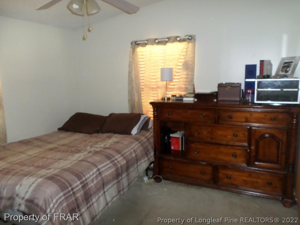 552 Lakerun Drive Bunnlevel, NC 28323 - Photo 16 of 31 a bed sitting in a bedroom next to a window