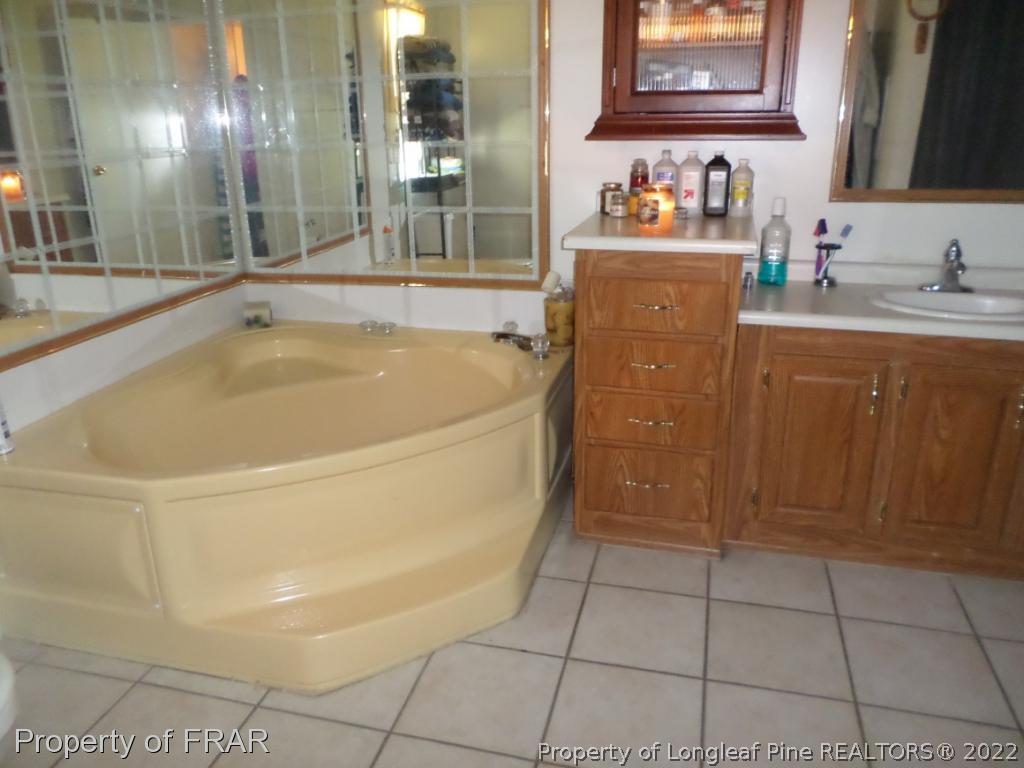 552 Lakerun Drive Bunnlevel, NC 28323 - Photo 18 of 31 a white bath tub sitting in a bathroom and sink
