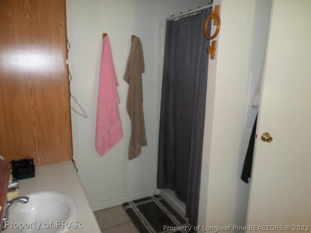552 Lakerun Drive Bunnlevel, NC 28323 - Photo 20 of 31 a bathroom with a sink and a mirror