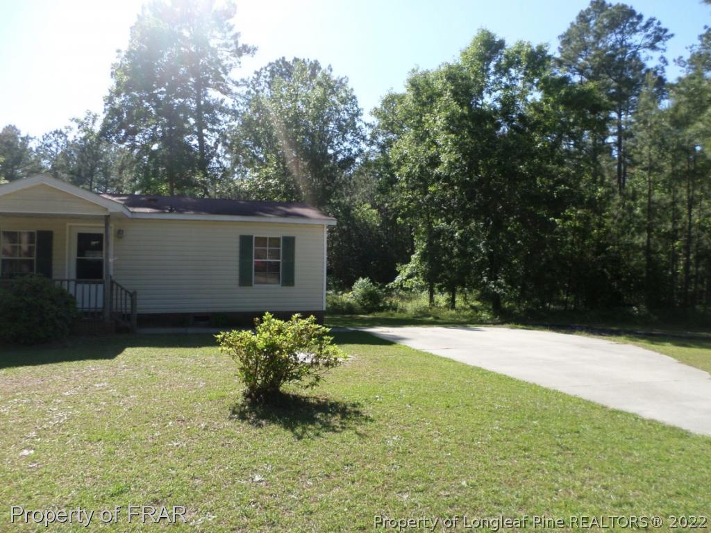 552 Lakerun Drive Bunnlevel, NC 28323 - Photo 2 of 31 a backyard of a house with yard and outdoor seating