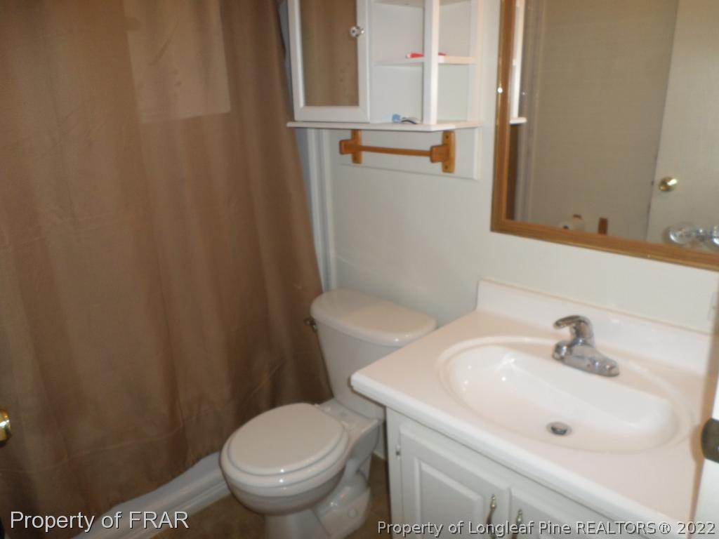 552 Lakerun Drive Bunnlevel, NC 28323 - Photo 24 of 31 a white toilet sitting next to a bathroom sink