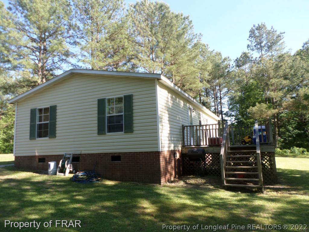 552 Lakerun Drive Bunnlevel, NC 28323 - Photo 25 of 31 a view of a house with a yard