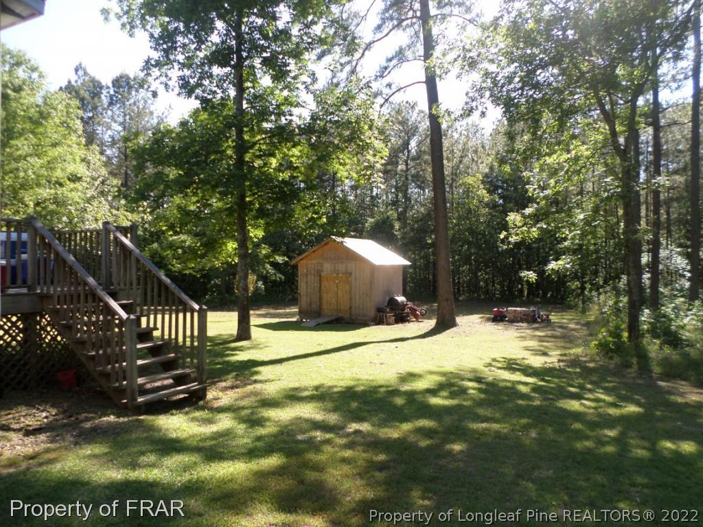 552 Lakerun Drive Bunnlevel, NC 28323 - Photo 27 of 31 a backyard of a house with a yard and outdoor seating