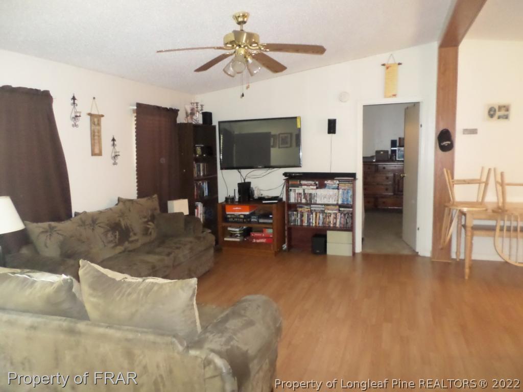 552 Lakerun Drive Bunnlevel, NC 28323 - Photo 6 of 31 a living room with furniture and a flat screen tv