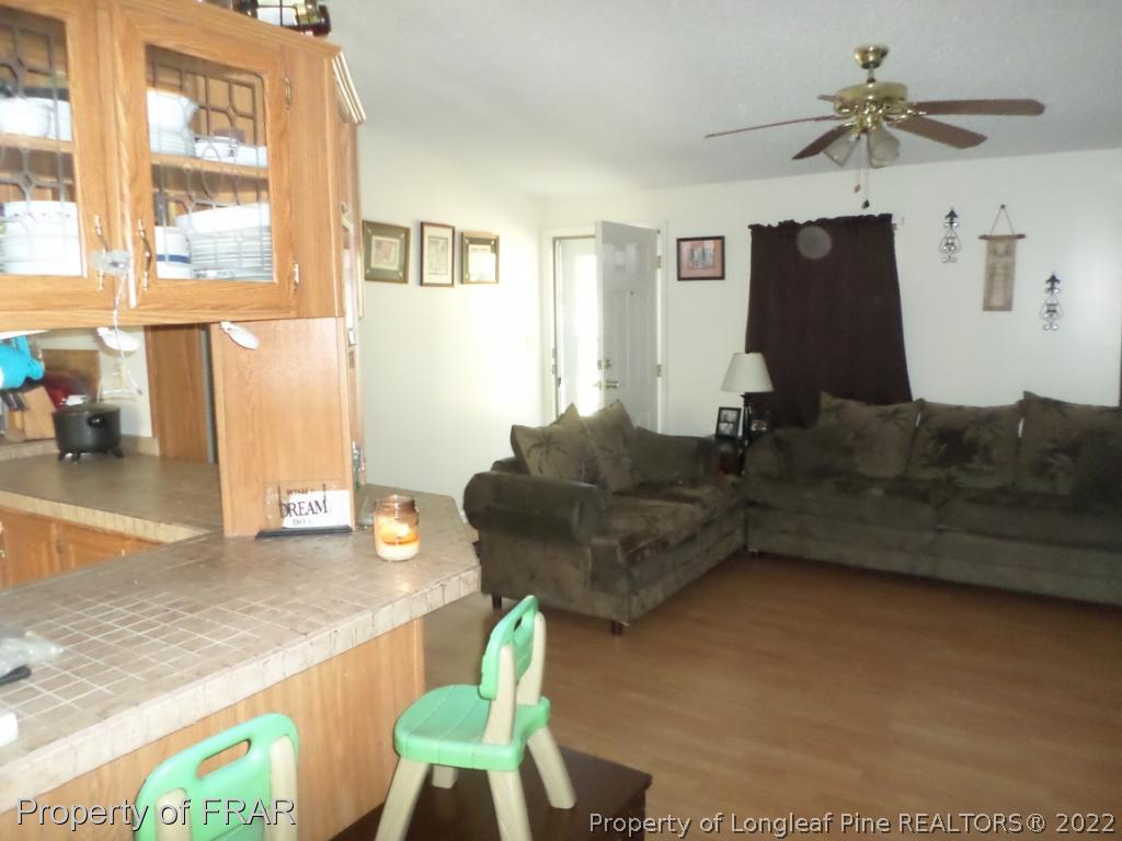 552 Lakerun Drive Bunnlevel, NC 28323 - Photo 7 of 31 a living room with furniture and a flat screen tv