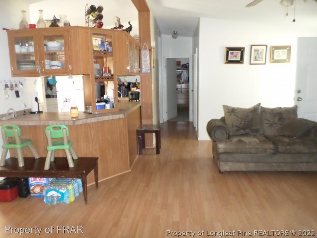 552 Lakerun Drive Bunnlevel, NC 28323 - Photo 8 of 31 a living room with furniture and a wooden floor