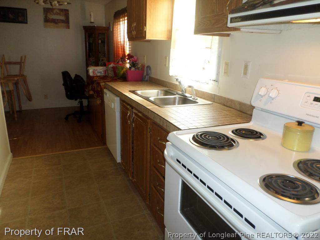 552 Lakerun Drive Bunnlevel, NC 28323 - Photo 9 of 31 a kitchen with a stove and a refrigerator