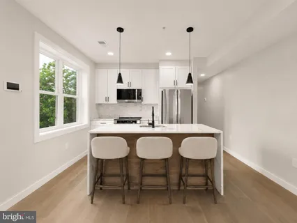 a large kitchen with a table and chairs