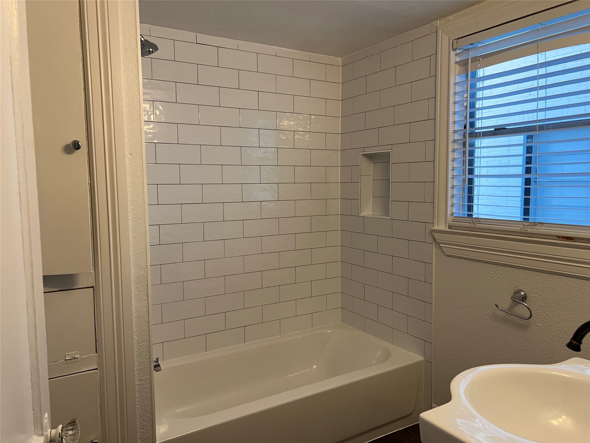 1853 West Main Street, Unit 2 Houston, TX 77098 - Photo 14 of 16 a bathroom with a bathtub and shower