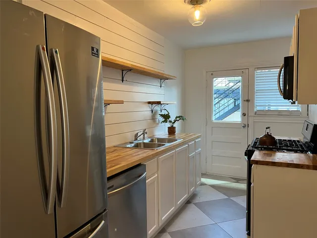 a kitchen with a refrigerator and a stove
