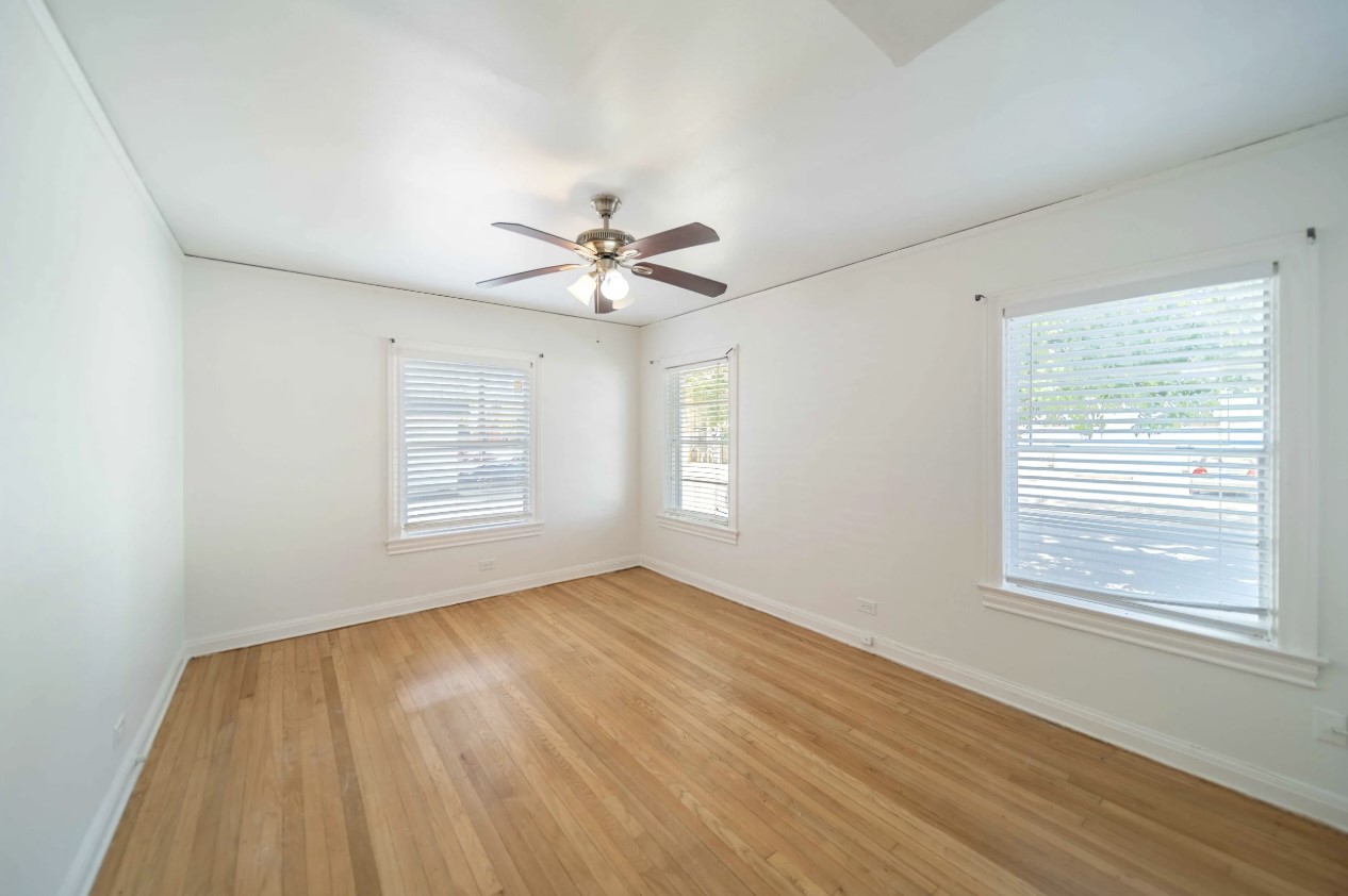 1853 West Main Street, Unit 2 Houston, TX 77098 - Photo 7 of 16 a view of an empty room with a window and wooden floor
