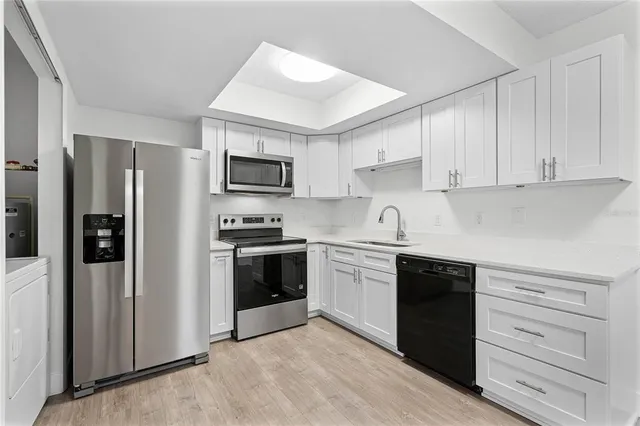 a kitchen with a refrigerator stove and sink