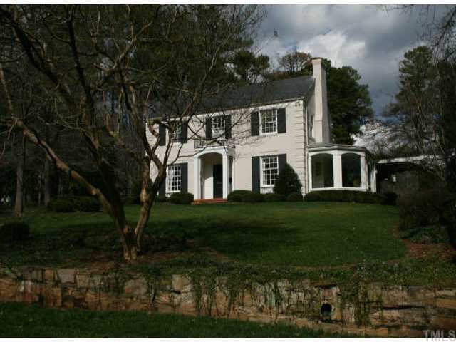 2614 Cooleemee Drive Raleigh, NC 27608 - Photo 1 of 12 a white house with a big yard plants and large trees