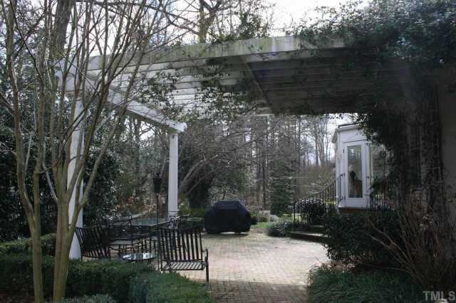 2614 Cooleemee Drive Raleigh, NC 27608 - Photo 4 of 12 a backyard of a house with lots of green space and fountain