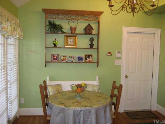 2614 Cooleemee Drive Raleigh, NC 27608 - Photo 10 of 12 a view of a dining room with furniture and wooden floor