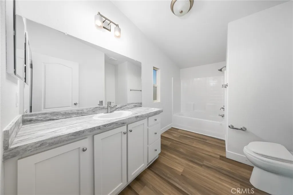 1855 East Riverside Drive, Unit 252 Ontario, CA 91761 - Photo 13 of 32 a bathroom with a granite countertop sink toilet and shower