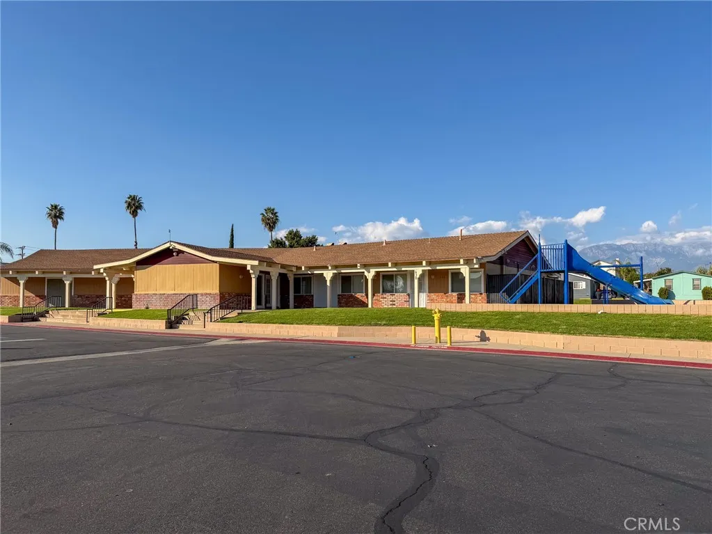 1855 East Riverside Drive, Unit 252 Ontario, CA 91761 - Photo 31 of 32 a front view of a house with a yard and garage