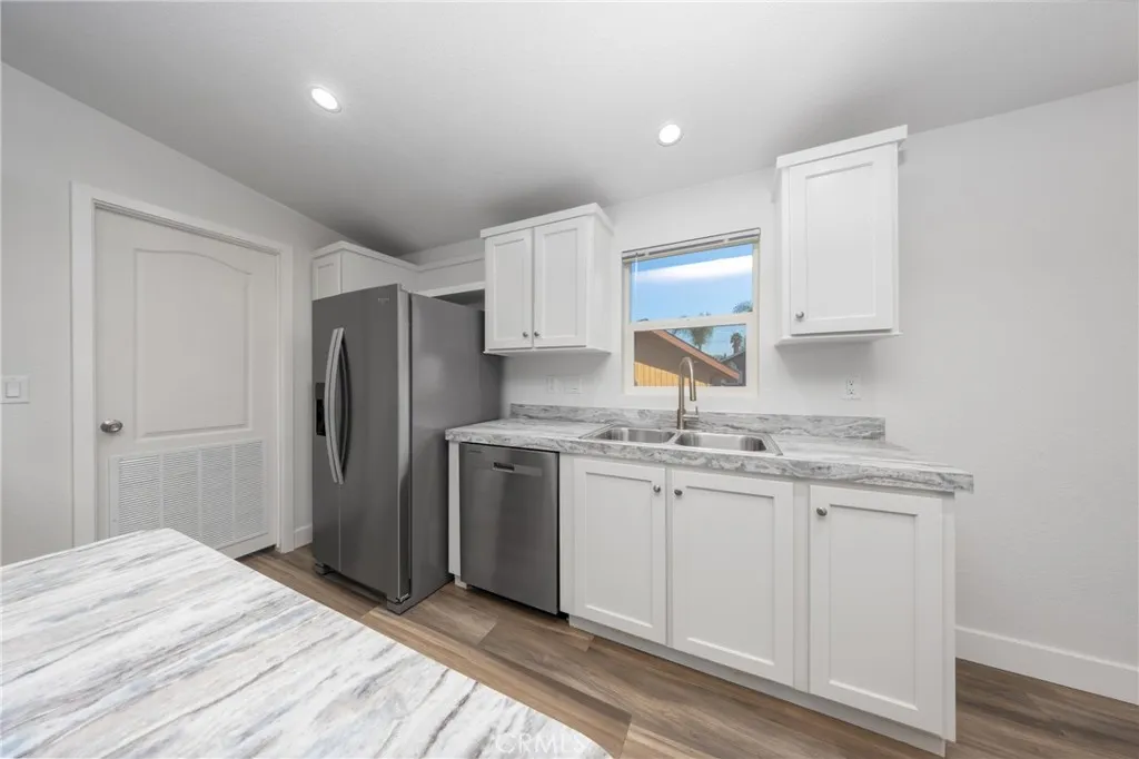 1855 East Riverside Drive, Unit 252 Ontario, CA 91761 - Photo 4 of 32 a kitchen with stainless steel appliances granite countertop a sink stove and refrigerator