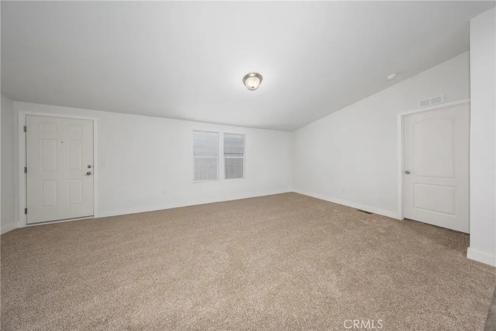 1855 East Riverside Drive, Unit 252 Ontario, CA 91761 - Photo 10 of 32 a view of an empty room with a window