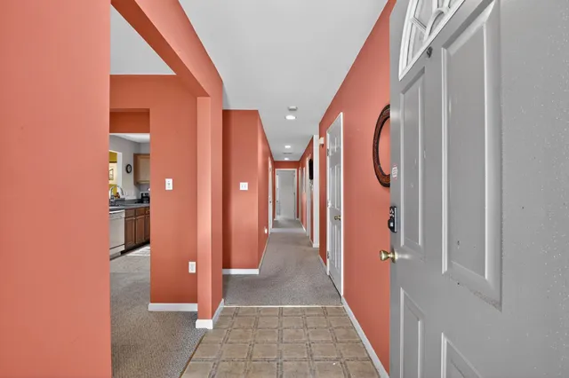 a view of hallway with wooden floor