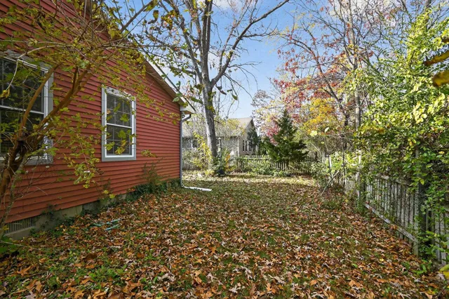 a view of a backyard with large trees