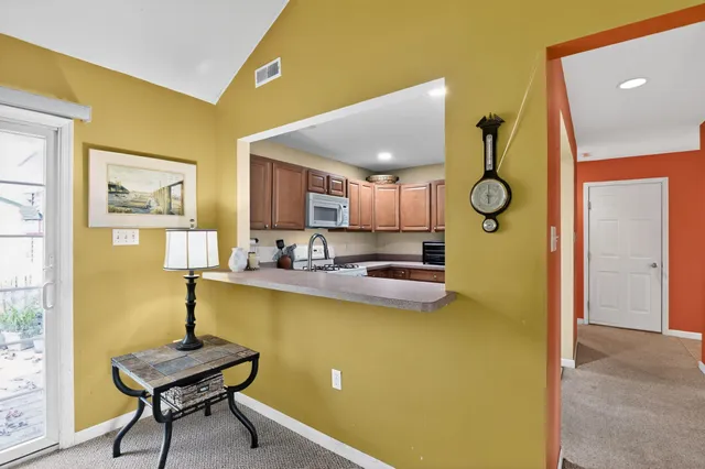 a living room with a table and a chair